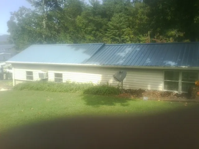 Blue metal roof running the length of a single story home in Woodsville